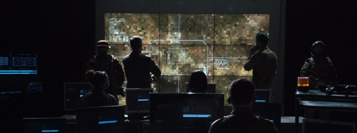 Group of people in dark room launching a missle DGCS work room environment